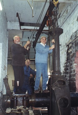 The Rescue and Rebuilding of Agnes: With very little head room to work in, the first section of the flywheel is lifted c