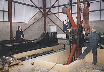 The Rescue and Rebuilding of Agnes: The crankshaft, with the flywheel hub attached, is carefully lowered into its bearin