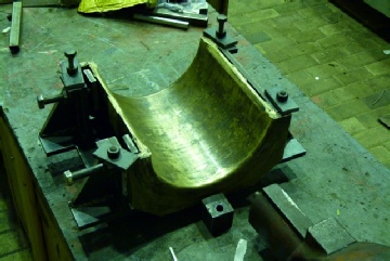 The original bottom brass fitted to the machining jig.