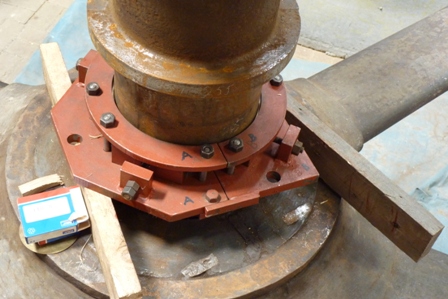 This shows the bottom split bearing in place, just above the flywheel hub. The adjusters in view are used to push the brass segments onto th