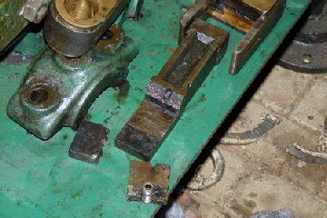 The broken cast component, on the Joseph Evans steam pump. Evidence of a previously brazed repair can be seen (next to the grub screw).