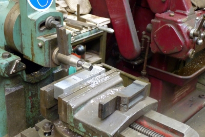 Machining a new part, from solid metal, using a shaping machine. It will to replace the broken casting, seen on the shaper vice.