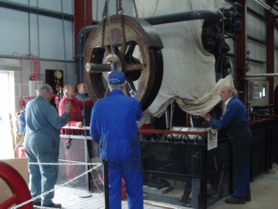The modified flywheel being lowered into place. The balancing weights can be seen quite clearly.