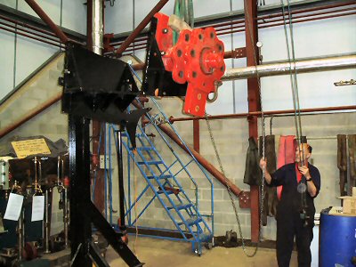 Hoisting the feathering hub onto the fabricated structure, prior to positioning it at the side of the paddle wheel. Each of the paddles, on 